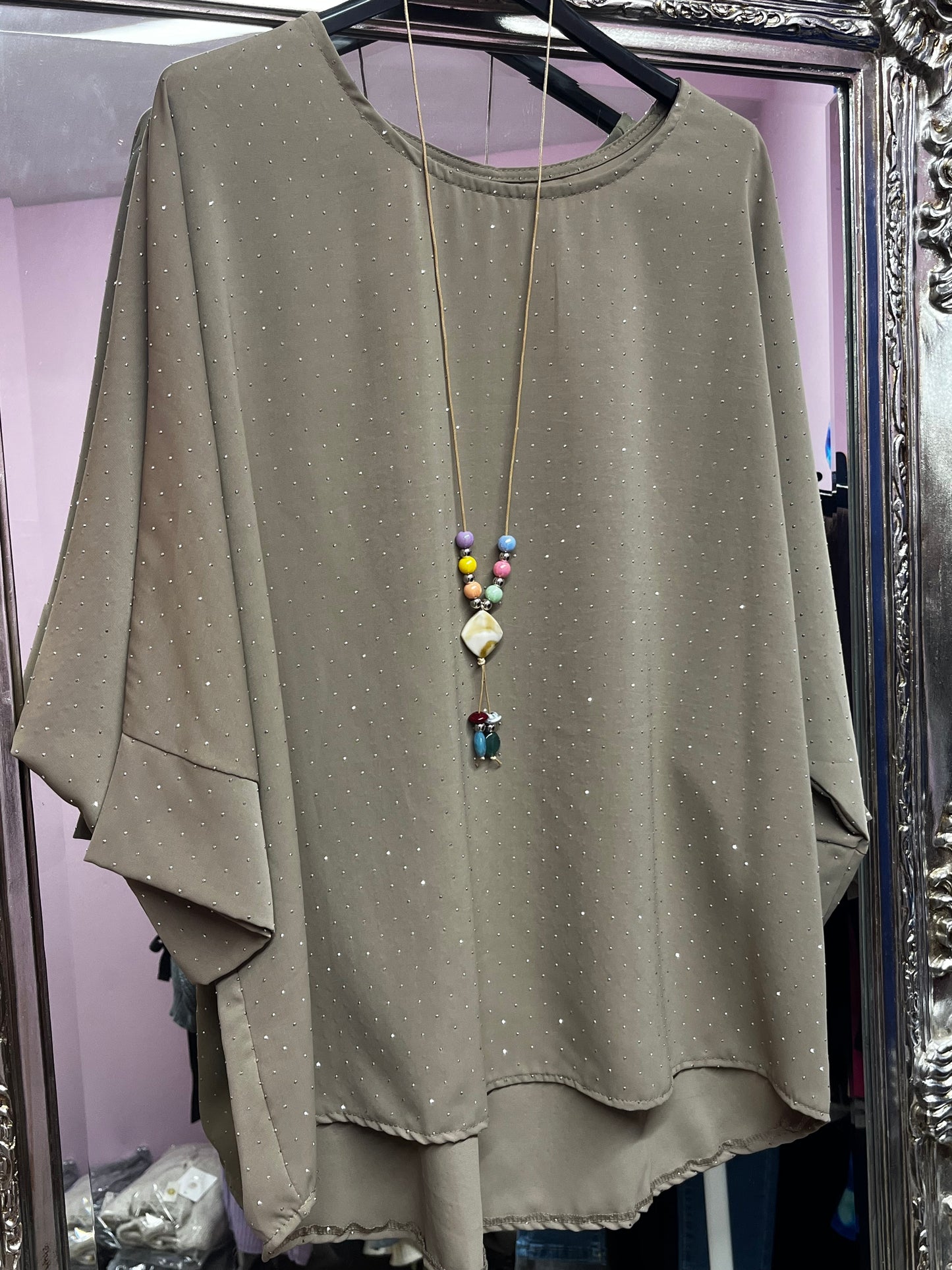 Plus size sparkly top with beaded necklace